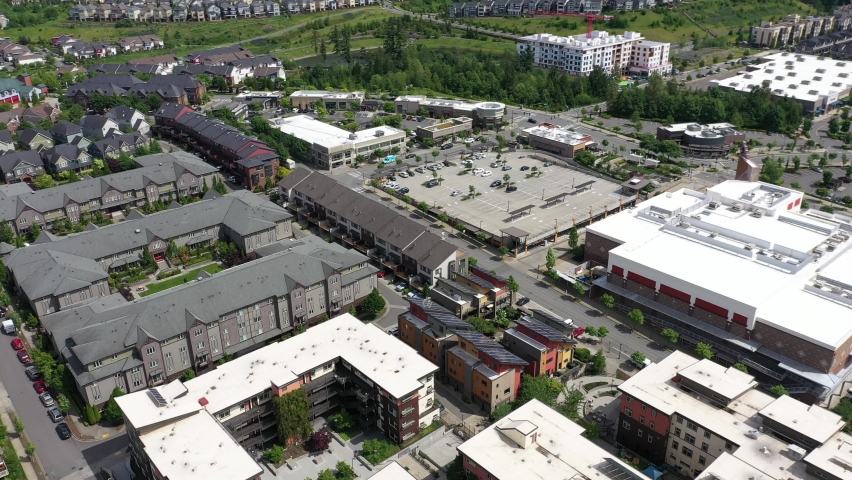 Cinematic aerial orbiting footage of the Issaquah Highlands, Grand Ridge Plaza, commercial and shopping area, in King County Washington, near Seattle and Bellevue in Western Washington