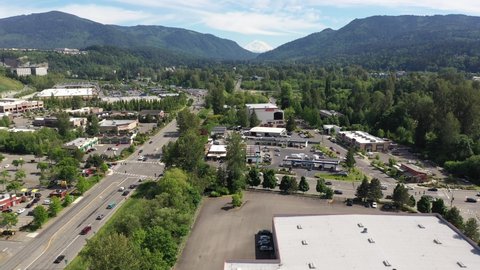 Cinematic aerial tracking footage of the Issaquah and Issaquah Highlands commercial and shopping area, in King County Washington, near Seattle and Bellevue in Western Washington