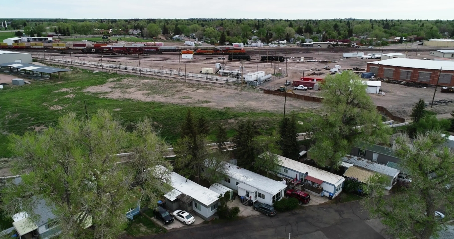 Mobile home park next to an industrial district showing poverty and wealth disparity in 2021.