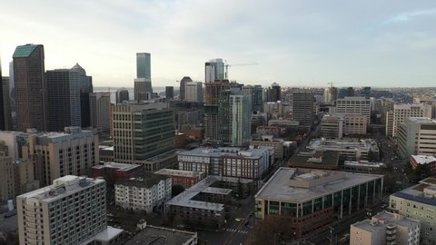 Cinematic aerial drone footage of First Hill, Yesler Terrace, Atlantic, Cherry Hill, Squire Park, skyscrapers and high-rise commercial and residential buildings downtown Seattle, Washington