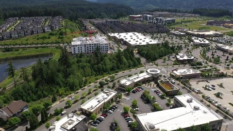 Cinematic aerial tracking footage of the Issaquah Highlands, Grand Ridge Plaza, commercial and shopping area, in King County Washington, near Seattle and Bellevue in Western Washington