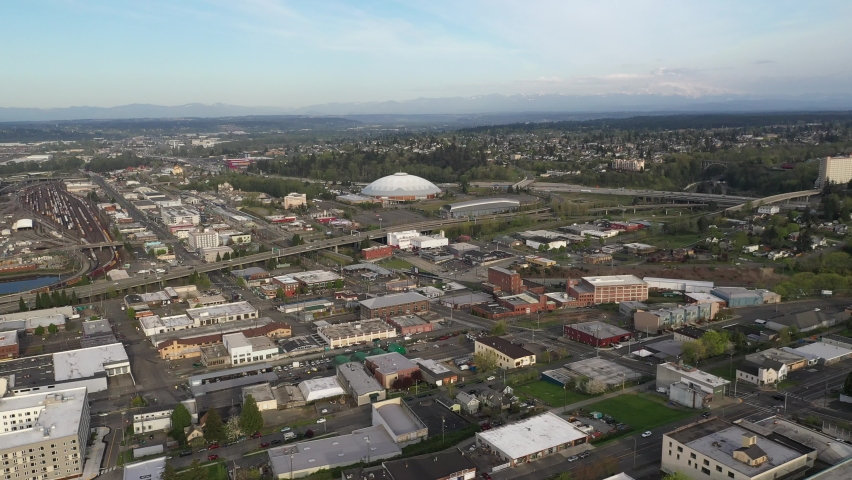 Cinematic 4K orbiting, drone footage of the Tacoma Dome and highway interchange downtown, a city near Seattle in Western Washington, Pacific Northwest, the economic center of Pierce County
