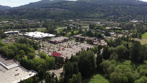 Cinematic drone tracking shot of the Issaquah, Issaquah Commons and Issaquah Highlands commercial and shopping area, in King County Washington, near Seattle and Bellevue in Western Washington