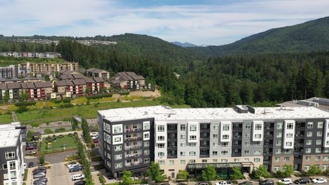 Cinematic aerial orbiting footage of the Issaquah Highlands, Grand Ridge Plaza, commercial and shopping area, in King County Washington, near Seattle and Bellevue in Western Washington