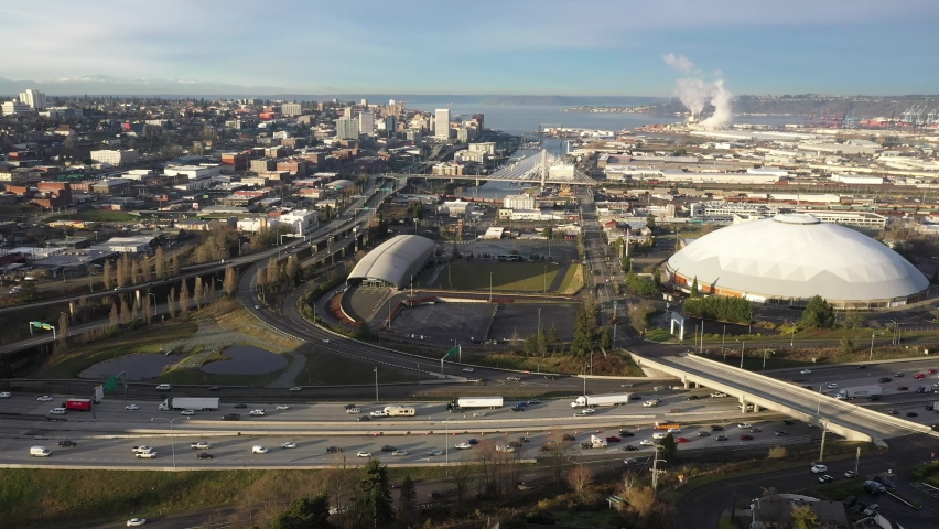 Cinematic aerial tracking shot of downtown Tacoma, harbor, dome, Commencement Bay, Puget Sound, port of Tacoma near Seattle, in Western Washington, Pacific Northwest, economic center of Pierce County