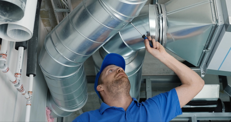 Hvac services - worker install ducted system for ventilation and air conditioning with recuperation