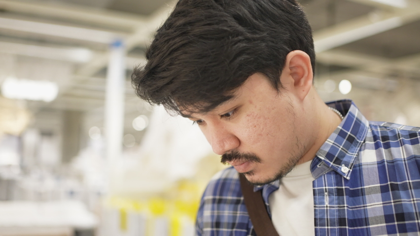 slow motion scene on adult middle eastern man wipe on white blanket to check quality fo product before make decision to buy at home decoration shopping mall for lifestyle concept