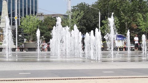 Krasnodar, Krasnodar Krai, Russia - July 28, 2013: Adults with children rest at the city fountain in Krasnodar