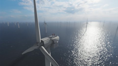 Workers on top of an offshore wind turbine against morning sun, low dof drone view 4K