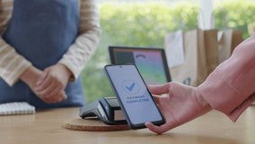 Close-up hand asia woman people work in small sme coffee café shop store owner use cashless wifi paywave nfc scan app smart pos reader sale in take out food drink order in urban city life contactless. - Powered by Shutterstock - Get 15% off with code: PIKWIZARD15