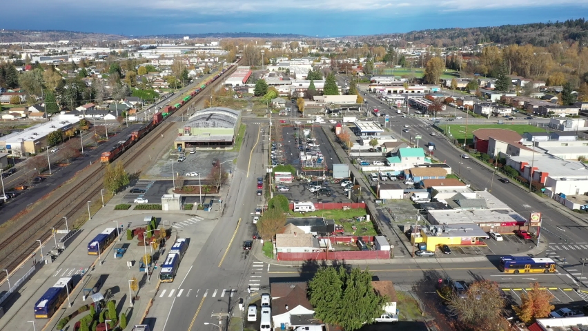 Aerial - drone footage of Kent Station, train tracks, a shopping area downtown Kent in the Green River Valley near East Hill, Scenic Hill, Auburn, all suburbs of Seattle, King County Washington