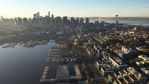 Sunrise aerial panning footage of East Queen Anne, Queen Anne, South Lake Union, Lower Queen Anne, Seattle Center, upscale, affluent neighborhoods uptown by Puget Sound, in Seattle, Washington