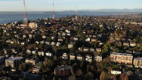 Sunrise Aerial - drone footage of East Queen Anne, Queen Anne, Lower Queen Anne, Seattle Center, upscale, affluent neighborhoods uptown by Puget Sound, in Seattle, Washington