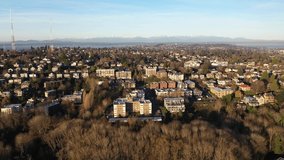 Cinematic orbiting sunrise drone footage of East Queen Anne, Queen Anne, Westlake, Kerry Park, upscale, affluent neighborhoods uptown by Puget Sound, in Seattle, Washington