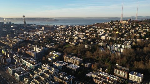Cinematic morning aerial footage of East Queen Anne, Queen Anne, Seattle Center, Space Needle, Belltown, Alki, upscale, affluent neighborhoods uptown by Puget Sound, in Seattle, Washington