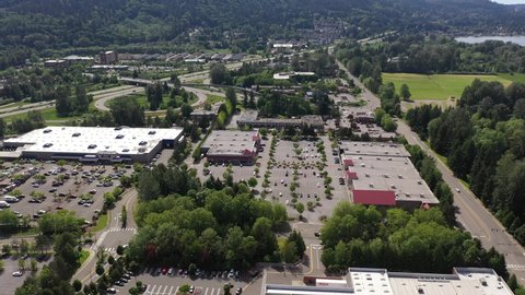 Cinematic drone tracking footage of the Issaquah, Issaquah Commons and Issaquah Highlands commercial and shopping area, in King County Washington, near Seattle and Bellevue in Western Washington
