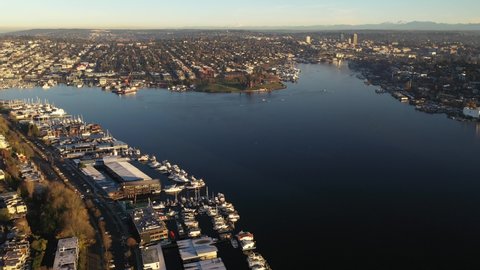 Cinematic tracking sunrise aerial footage of Lake Union, Northlake, Eastlake, North Broadway, Gas Works Park. University district, affluent neighborhoods uptown by Puget Sound, in Seattle, Washington