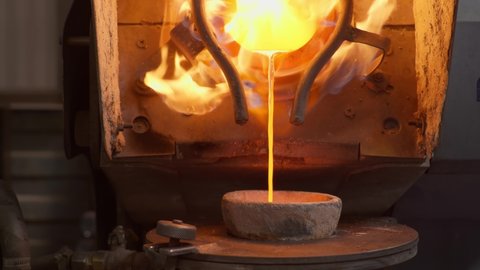 The molten metal is poured into the smelter bowl at the plant for production items out of silver