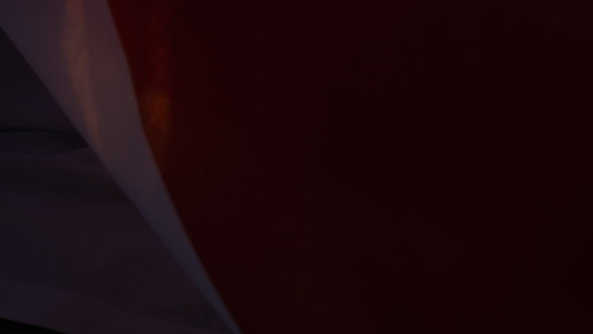 Selective focus view from back of young mother and cute daughter running with American flag during sunset. 4 of July, Independence day celebration. Slow-motion. Patriotic holiday, democracy concept