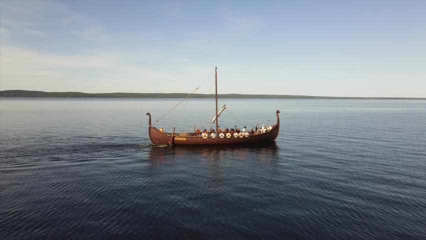 Viking ship with tourists floats on the lake against the blue sky Royalty-Free Stock Footage #1073841068