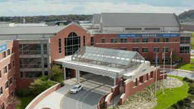 Healthcare Heroes Work Here sign at entrance of American medical hospital in USA. COVID-19 pandemic honors doctors and nurses, essential workers. - Powered by Shutterstock - Get 15% off with code: PIKWIZARD15