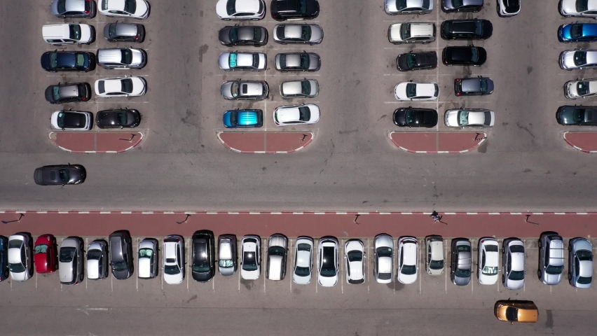 Parking lot, Aerial view of Cars entering, leaving and searching for available parking space.