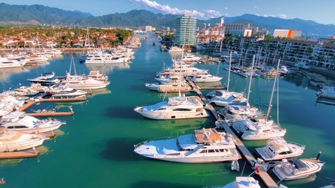 View of Marina and yacht club area in Puerto Vallarta near El Faro lighthouse with luxury hotels around.