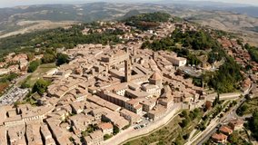 A picturesque view of the town of Volterra in Tuscany, Italy. Panorama of the city from a bird's-eye view. Narrow streets and roofs made of shingles and tile. Travel Italian concept. Drone video.