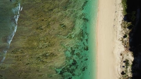 Top down view on sandy Pandawa beach with reef in Bali Indonesia. High quality 4k aerial birds view footage