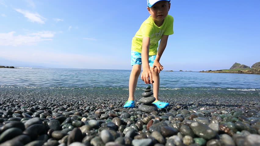 Asian boy plays near the sea