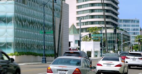 LOS ANGELES, CALIFORNIA, USA - APRIL 6, 2021: Cars traffic on Wilshire Boulevard near Waldorf Astoria Beverly Hills Hotel and Century City skyline in Los Angeles, California, 4K