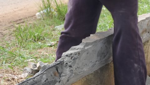 worker builder using hammer and smash tool at construction site. Man using sledge-hammer. Labor are using hammer smash destroy cement wall