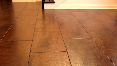 Big flooring tiles installed in beautiful home, tiles are made of ceramic material and with reddish textures