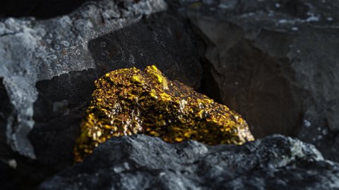 Golden colored rock hidden between rocks.