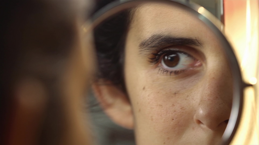 Girl Looks In The Mirror closeup.