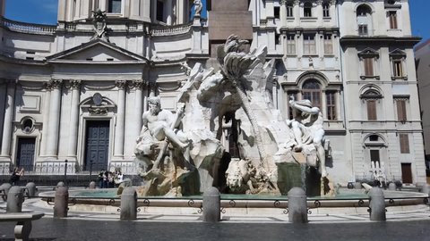 Europe, Italy  June 2021 - Hyper lapse of  Statue of the god Zeus in Bernini's Fountain of the Four Rivers in the Piazza Navona, Rome - detail of the allegorical Ganges figure and obelisk 
