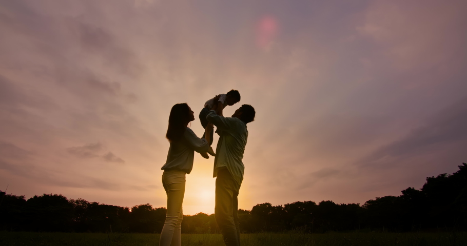 Slow motion shot - silhouette of asian parent play with kid and dad hug the boy | Shutterstock HD Video #1073880170