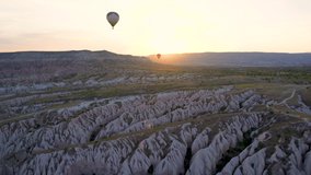 Beautiful scenic landscape of Cappadocia, Goreme city, Turkey country. 4k stock video footage of colorful hot air balloons flying in morning at sunrise time. View from basket of balloon during flight