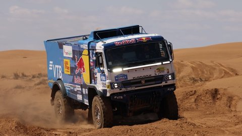 Sports truck KAMAZ gets over the difficult part of the route during the Rally raid in sand. THE GOLD OF KAGAN-2021. 25.04.2021 Astrakhan, Russia.