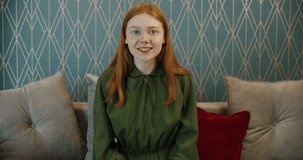 A young woman with red hair communicates by video call. Communication with friends and during training. High quality 4k footage