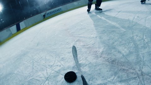 POV: Ice Hockey Professional Forward Player Dribbles, Hitting Puck with Stick Scores Perfect Goal when Goalie Misses. Cinematic Documentary Style Camera Fixed on Hockey Stick. Point of View Shot