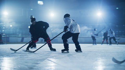 Ice Hockey Rink Arena: Young Players Training, Learning Stick and Puck Handling. Athletes Learn how to Dribble, Attack, Defense, Protect, Possession, Carrie the Puck. Cinematic Medium Shot