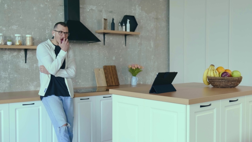 Caucasian young entrepreneur is having a business meeting while using a tablet and eating an apple  - Powered by Shutterstock - Get 15% off with code: PIKWIZARD15