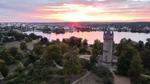 Aerial dolly shot of Flatow tower in Babelsberg Park, Potsdam during sunset