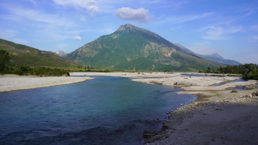 Panoramic river landscape with beautiful mountain and cloudy sky background in Albania