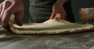 Professional chef carefully shaping dough for Italian pizza. Cooker using traditional methods to make pizza. Food and drink close up 4k footage