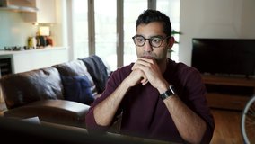 Mixed race business man working from home shaking head frustrated with work