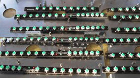 Slider shot video of LED light indicators PCB boards on workshop table. Research of high-frequency radio electronic components in a scientific laboratory. 4K UHD realtime pan video
