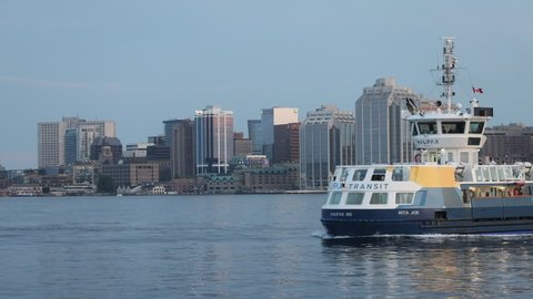 Halifax, Nova Scotia, Canada 06 08 2021 - Halifax Ferry Transport operating between Dartmouth and Halifax at the backdrop of Halifax Harbor Waterfront and Skyline. Oldest ferry route of North America 