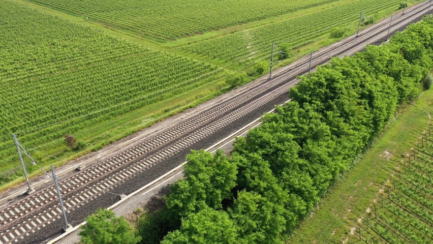 Two trains of red color movement aerial view. The movement of trains at high speed between the vineyards, top view. | Shutterstock HD Video #1073914229